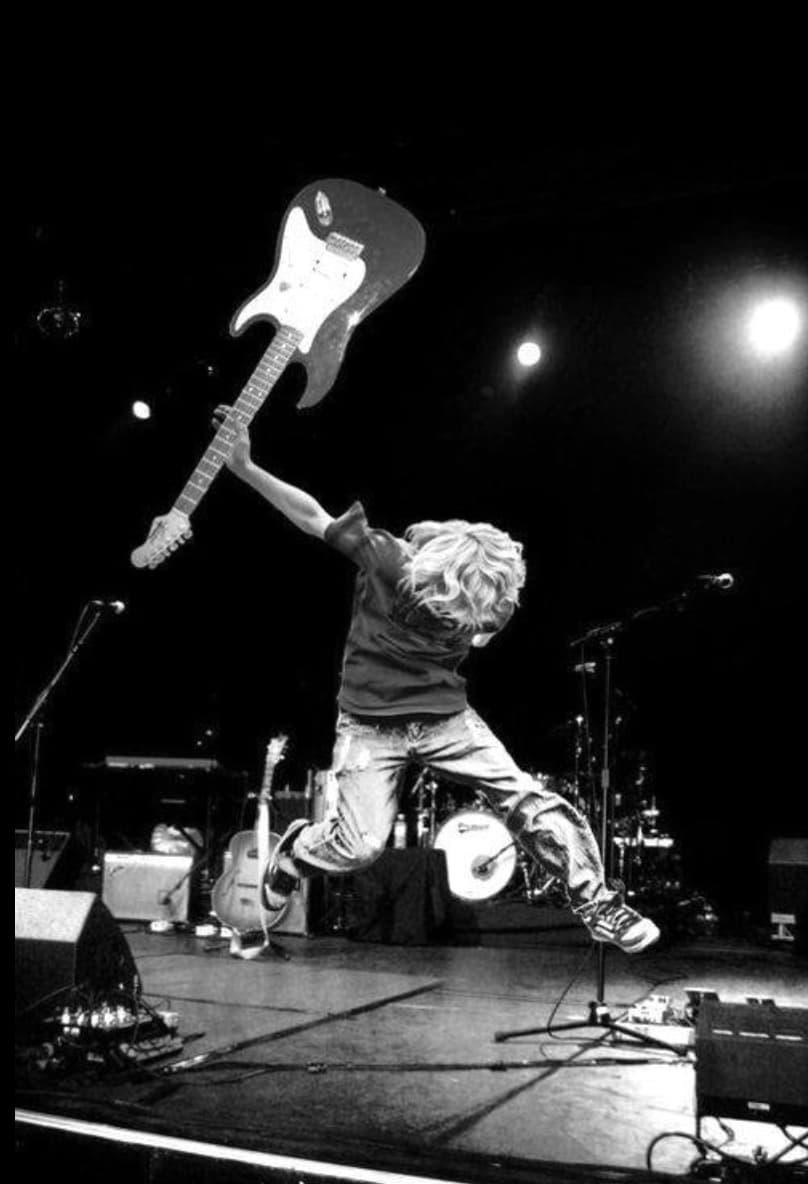 A young Kurt Cobain smashes a guitar, October 1988. 